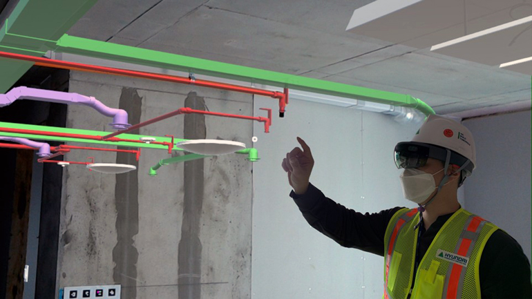 An operator with an AR wearable device is checking construction location and work environment. 